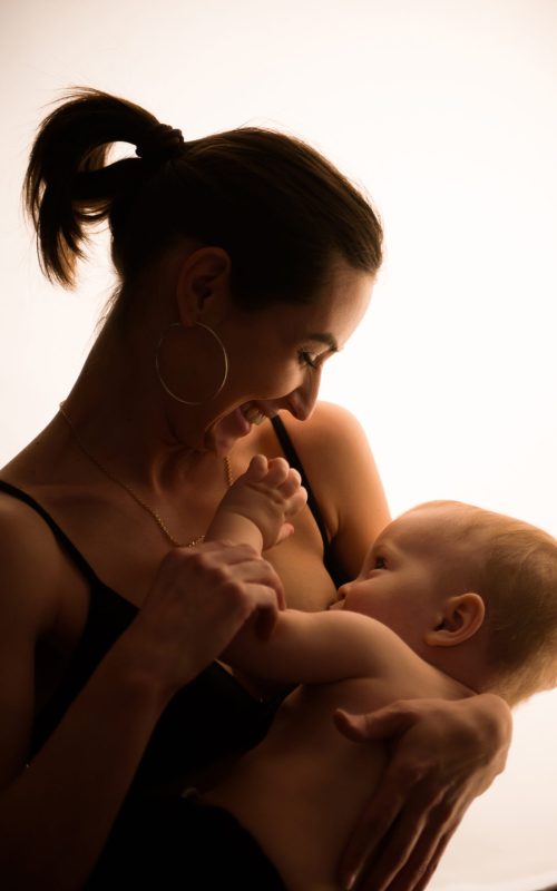 Bright portrait of a mom breast feeding baby.
